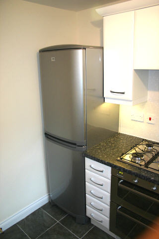 Kitchen with fridge freezer, dishwasher gas hob double oven and washer/drier