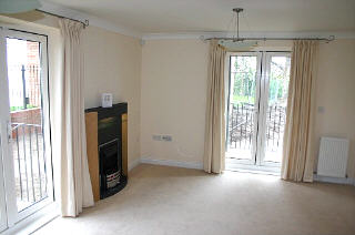 Lounge with electric fire and two patio areas (with railings)